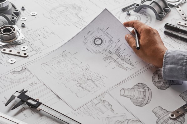 Engineering and technical personnel design drawings, mechanical engineering, engine parts, manufacturing factories, industrial measurement, bearings, calipers, tools, industrial project blueprints